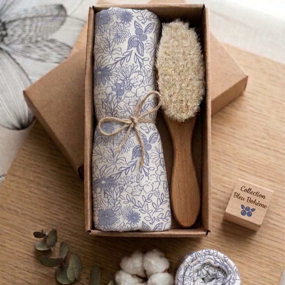 Coffret Douceur de coton, composé d'une brosse et d'un lange, posé sur une table