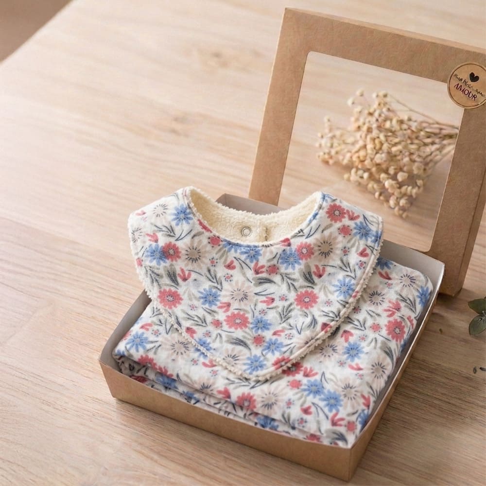 Box Petite Citrouille Emma composé d'un bavoir et d'un lange dans des motifs fleuris bleus et roses